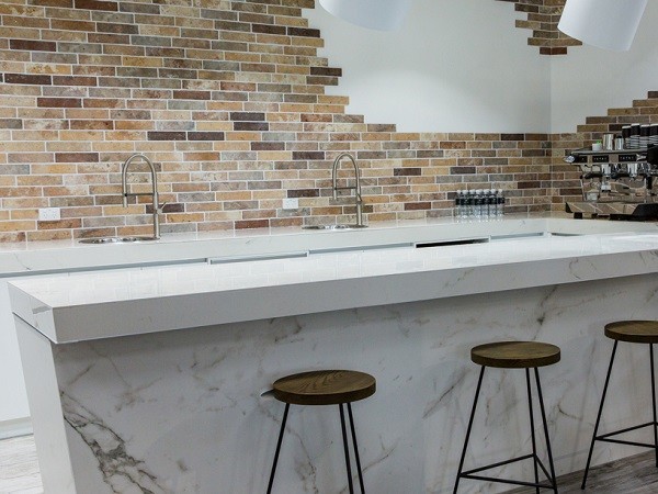 Imperfections add beauty to brick tiled wall in Studio Cafe