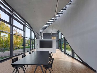 A narrow opening in the ceiling runs diagonally across the entire structure, creating bright skylights across all interior spaces (Photo Credit: Stefan Mueller)
