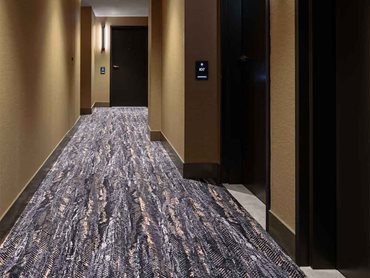 The custom Designer Jet carpet influences wayfinding in the hallways 