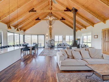 Exposed rafters and ply ceilings were integrated inside the home, using timber harvested onsite