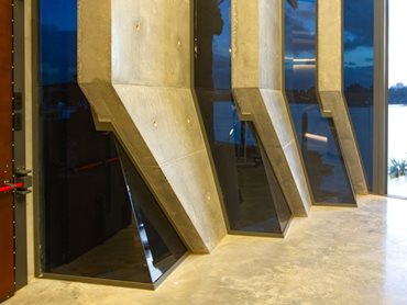 The faceted glazing elements integrated into the  polished concrete structure 