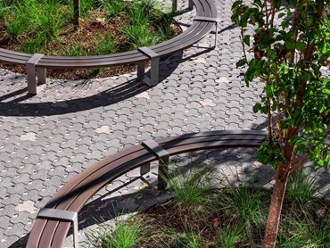Encircling planting beds, the seating design promotes informal social gatherings and interactions