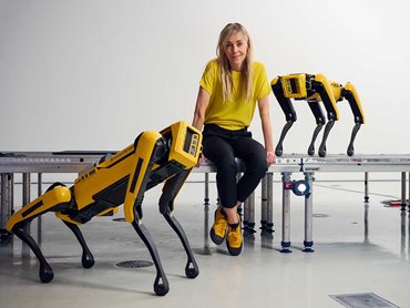 Portrait of Agnieszka Pilat with her quadruped robot dogs Bonnie Spot and Basia Spot at the announcement of the 2023 NGV Triennial exhibition. Photo: Eugene Hyland