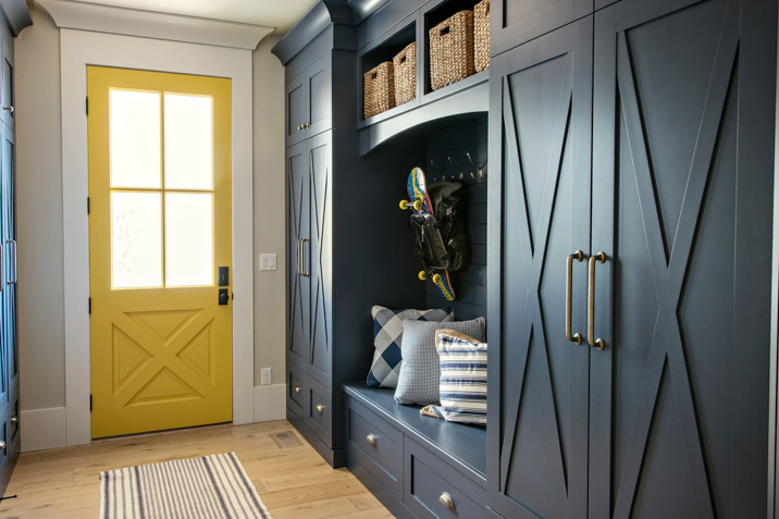blue and yellow vintage mudroom design with storage and cabinets