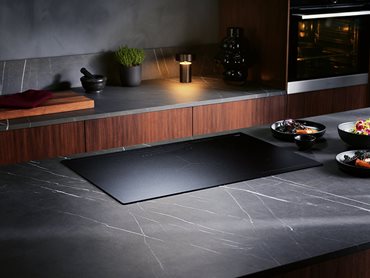 The matte black finish is less reflective than standard ceramic glass for a contemporary aesthetic