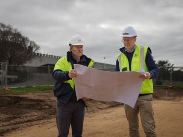 Clinton and Mitchell Taylor examining plans of the new build