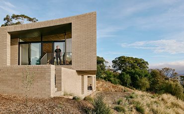 light brick house large window black framing