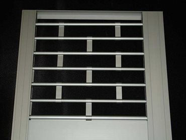 The security roller grille features toughened extruded metal links to provide a good security deterrent