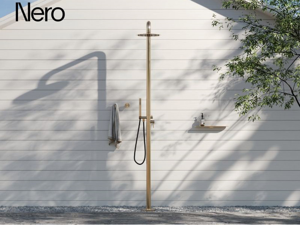 An outdoor freestanding shower column in brushed gold from the Zen Collection