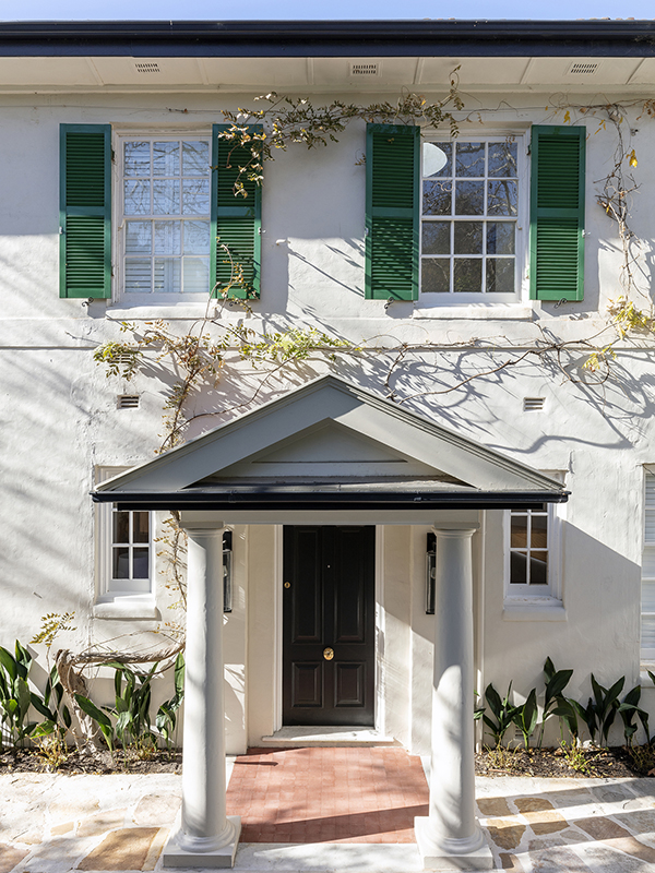 Guided by a formal black and white palette, injections of emerald green, textural velvet accents and assorted pattern work including v-jointed wall panelling, herringbone tiling and viridescent floral wallpaper animate the home.